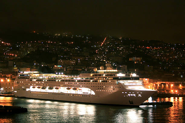 Celebrity Beyond cruise ship illuminated at night, sailing under a starry sky."